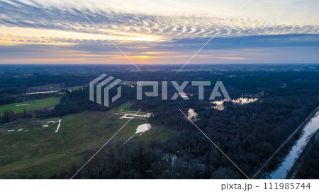 Aerial View of Sunset Over a Serene Landscape Aerial View of Sunset Over a Serene Landscape 111985744