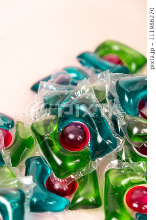Laundry capsules on beige background close-up Laundry capsules on beige background close-up 111986270