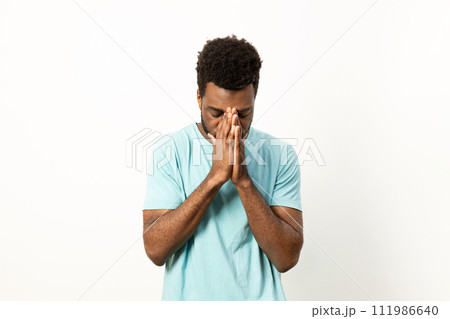 Stressed Young Man Facing Burnout with Hands on Face Stressed Young Man Facing Burnout with Hands on Face 111986640