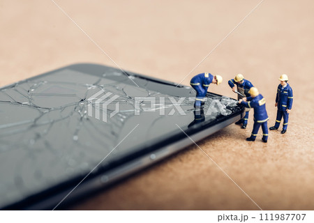Team of specialists repairing broken phone. Technology concept Team of specialists repairing broken phone. Technology concept 111987707