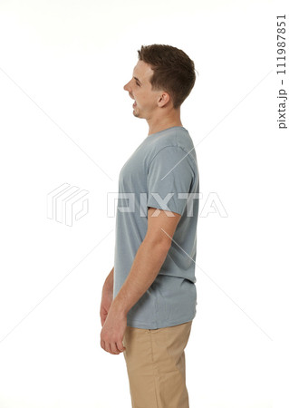 surprised guy looking at camera on white studio background 111987851