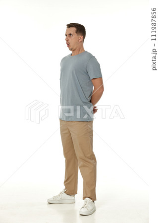 surprised guy looking at camera on white studio background 111987856