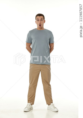 surprised guy looking at camera on white studio background 111987857