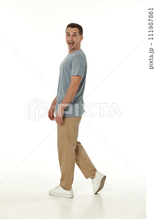 surprised guy looking at camera on white studio background 111987861