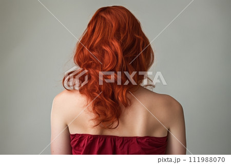 AI-generated content. Rear view of a girl with flowing long red hair, care and hair care concept 111988070