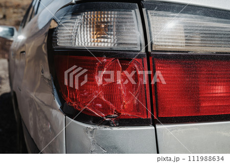 old car after an accident with damaged broken taillight close-up 111988634
