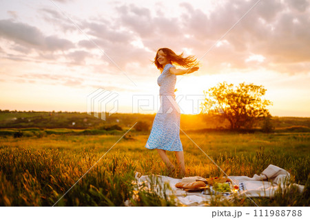 Young woman sits on a plaid with a book. Summer picnic in nature. Healthy food. Young woman sits on a plaid with a book. Summer picnic in nature. Healthy food. 111988788