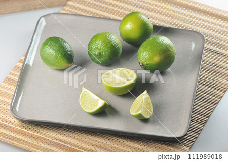 sliced limes on a gray sliced limes on a gray 111989018