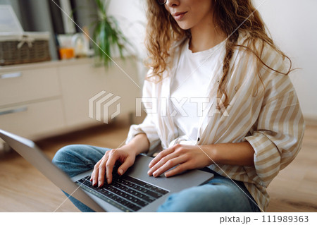 Close-up of woman's hands on a laptop keyboard, typing on modern laptop at home. Freelancing concept 111989363