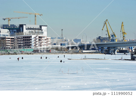 fishermen on ice fishing on fishing rods on the Moscow river 111990052