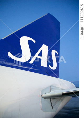 COPENHAGEN, DENMARK - NOV 24, 2018: View of the blue SAS Scandinavian Airlines logo on the tail unit of the Airbus A320 during boarding via the rear door 111990815