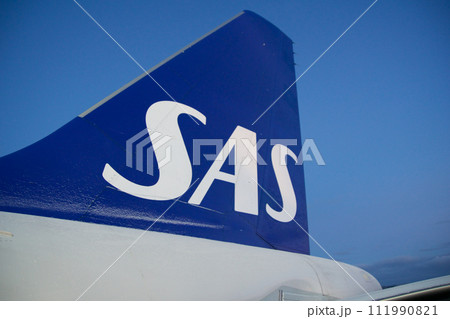 COPENHAGEN, DENMARK - NOV 24, 2018: View of the blue SAS Scandinavian Airlines logo on the tail unit of the Airbus A320 during boarding via the rear door 111990821