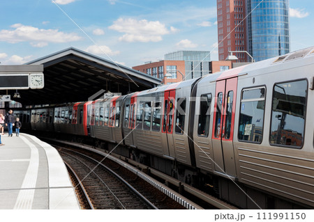 Hamburg Red Unmanned U-bahn Subway train rail Baumwall station on Elevated Track with Hamburger Port Harbor Elbphilharmonie building background blue sky. Hanseatic city commute transport scenic view Hamburg Red Unmanned U-bahn Subway train rail Baumwall station on Elevated Track with Hamburger Port Harbor Elbphilharmonie building background blue sky. Hanseatic city commute transport scenic view 111991150