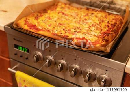 Scrumptious pizza with melting cheese, slices of sausage, and fresh cucumbers Scrumptious pizza with melting cheese, slices of sausage, and fresh cucumbers 111991199