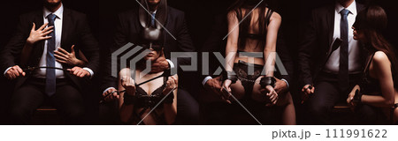 BDSM couple sex. Dominant men boss in a suit with a flogger whip dominates a submissive slave woman bottom girl in handcuffs and a mask BDSM couple sex. Dominant men boss in a suit with a flogger whip dominates a submissive slave woman bottom girl in handcuffs and a mask 111991622