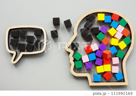 Black and colored cubes in the head and a negative comment. Black and colored cubes in the head and a negative comment. 111992169