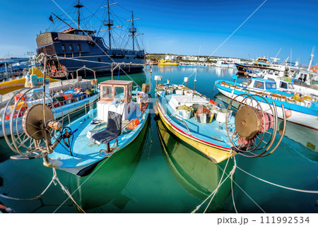 Tourist "Pirate ship" and moored fishing boats in harbour at Ayia Napa. Famagusta District. Cyprus Tourist "Pirate ship" and moored fishing boats in harbour at Ayia Napa. Famagusta District. Cyprus 111992534