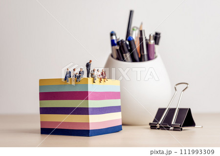 Businesspeople meeting in a miniature office 111993309