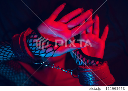 female hands in leather BDSM handcuffs. Submissive woman slave girl is lying on bed. Hardcore sex with submission, domination, punishment and violence female hands in leather BDSM handcuffs. Submissive woman slave girl is lying on bed. Hardcore sex with submission, domination, punishment and violence 111993658