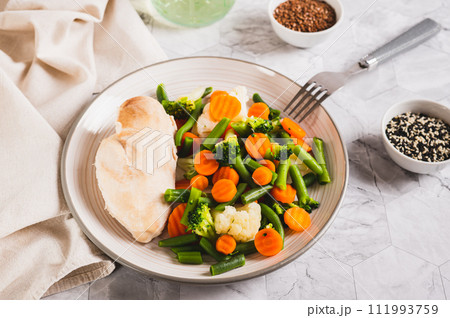 Boiled assorted vegetables and chicken fillet for diet food on a plate 111993759