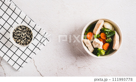Diet soup with chicken fillet and boiled vegetables in a bowl on the table top view web banner Diet soup with chicken fillet and boiled vegetables in a bowl on the table top view web banner 111993778