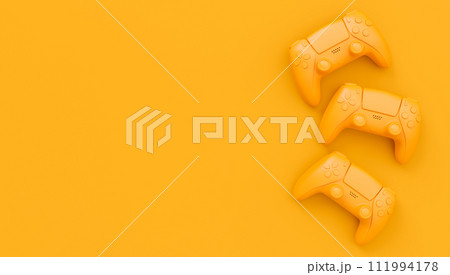Video game joysticks or gamepads in plain monochrome yellow color background 111994178