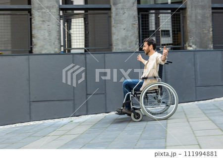 Young man on a wheelchair feeling free and excited 111994881