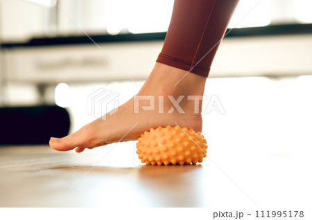 Myofascial relaxation of muscles of foot with massage ball Myofascial relaxation of muscles of foot with massage ball 111995178