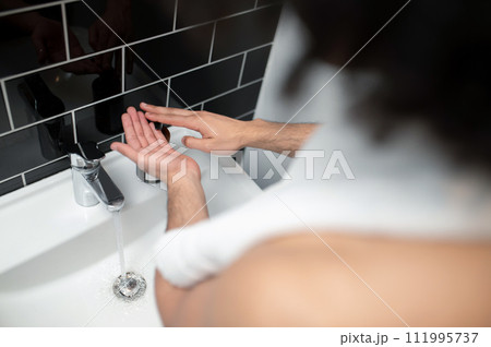 Close up picture of a man washing his hands Close up picture of a man washing his hands 111995737