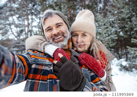 Mature couple looking happy and making selfie Mature couple looking happy and making selfie 111995869