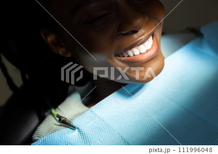 Multiracial woman in dentistry treating her teeth Multiracial woman in dentistry treating her teeth 111996048