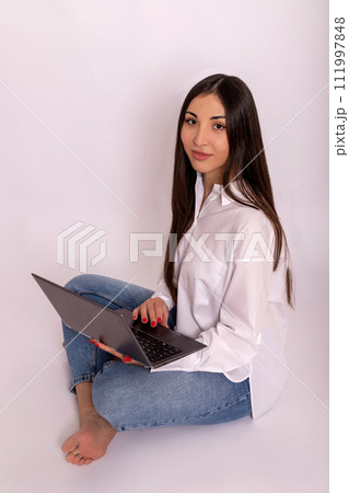 Young woman using laptop in hands on white background. Remote work online Young woman using laptop in hands on white background. Remote work online 111997848