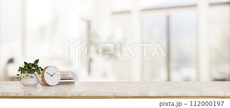 A luxury white marble tabletop with a copy space with a blurred background of a bright living room. 112000197