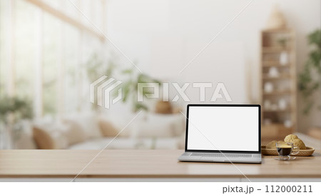 Home workspace, A white-screen laptop on a wooden table in a modern Scandinavian living room. 112000211