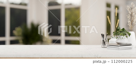 A table with empty space for display product with a blurred background of a modern white living room 112000225