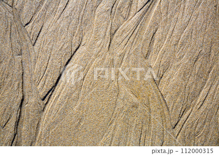 Patterns on the sand from sea water after low tide, Spain 112000315