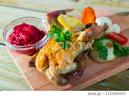 Grilled hen with cranberry sauce and broiled vegetables Grilled hen with cranberry sauce and broiled vegetables 112000435