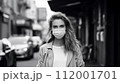 屋外でマスクをしている若い女性 112001701