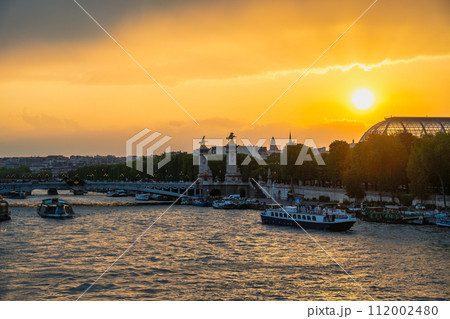 Paris France, city skyline sunset at Seine River with Pont Alexandre III bridge and Grand Palais 112002480