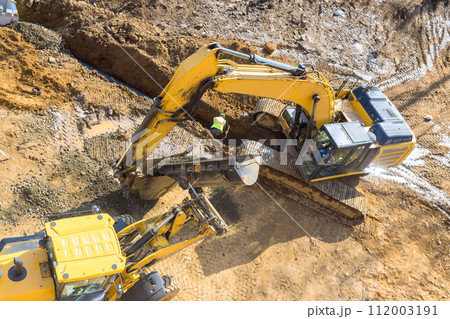 In this large excavator is digging on an industrial site that is being developed an infrastructure project 112003191