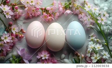 Pastel-colored Easter eggs nestled among delicate pink cherry blossoms and spring flowers, conveying a soft, tranquil setting. 112003638