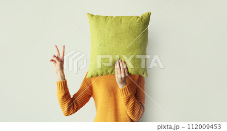 Healthy sleep, woman holding colorful soft pillow covering her head at home in morning Healthy sleep, woman holding colorful soft pillow covering her head at home in morning 112009453