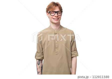 young handsome caucasian guy with red hair in a brown shirt 112011380
