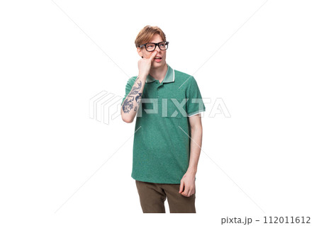 young european guy with red hair in glasses picks his nose young european guy with red hair in glasses picks his nose 112011612