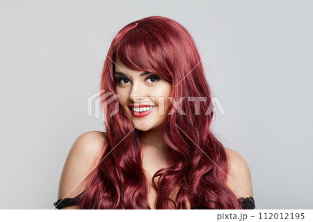 Bright redhead woman fashion model with long healthy shiny wavy hair posing Bright redhead woman fashion model with long healthy shiny wavy hair posing 112012195