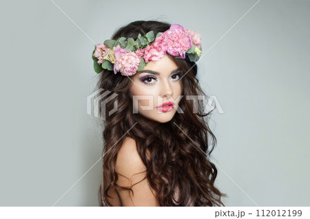 Attractive fashion model woman with fresh skin, long dark wavy hair styling and makeup 112012199