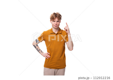 a young handsome red-haired man with a haircut and a tattoo on his arm tells the news. advertising 112012216