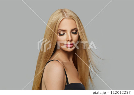 Good-looking blonde female model with make-up and straight healthy shiny hairstyle 112012257