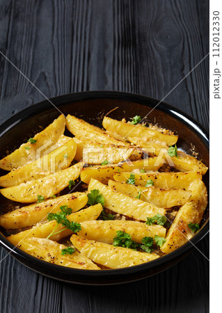 greek lemon potatoes with garlic, cheese on dish 112012330