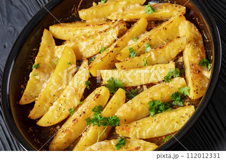 greek lemon potatoes with garlic, cheese on dish 112012331